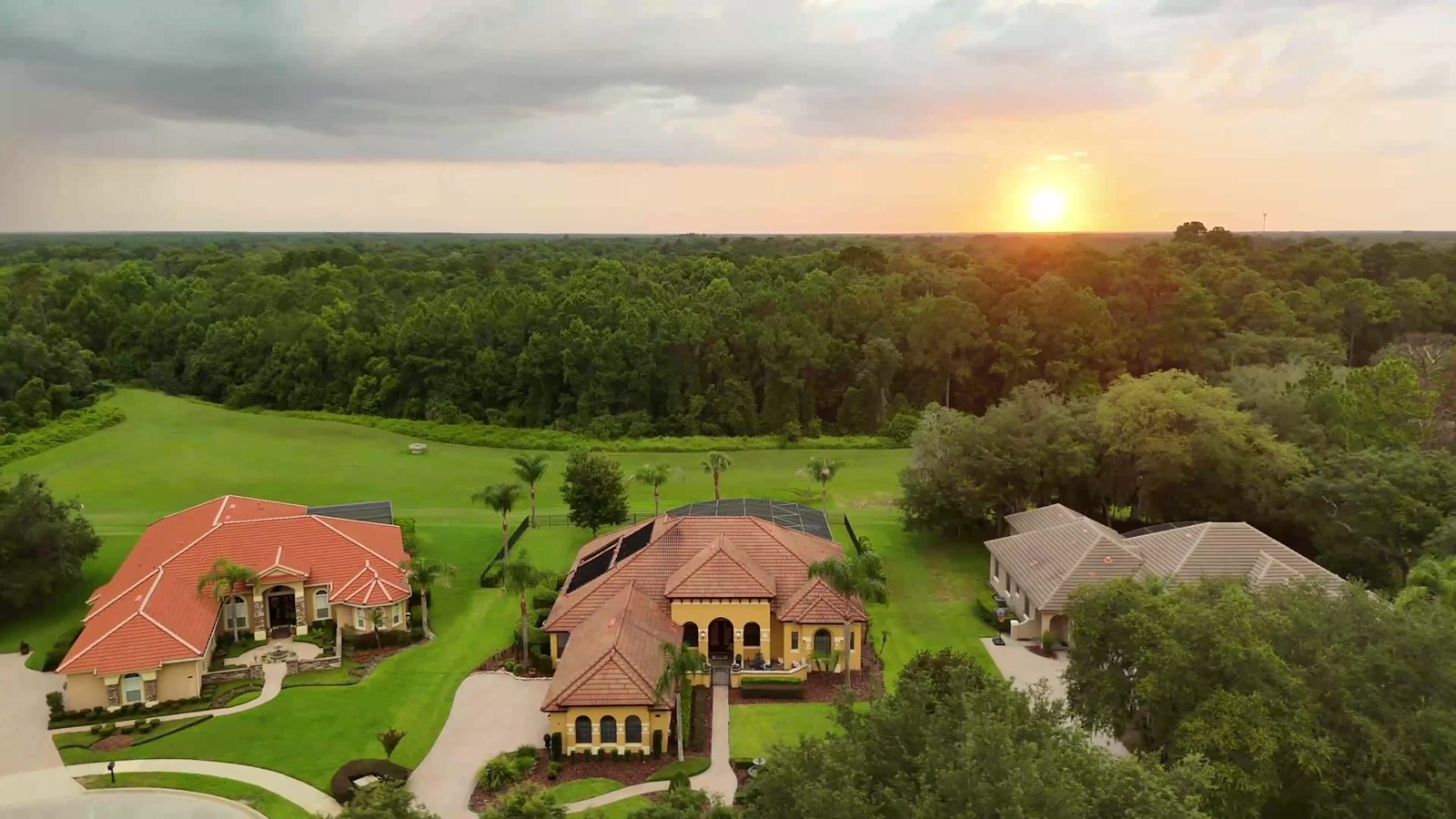 Aerial sunset view of the Sanford luxury estate on a large lot backing to trees and open space