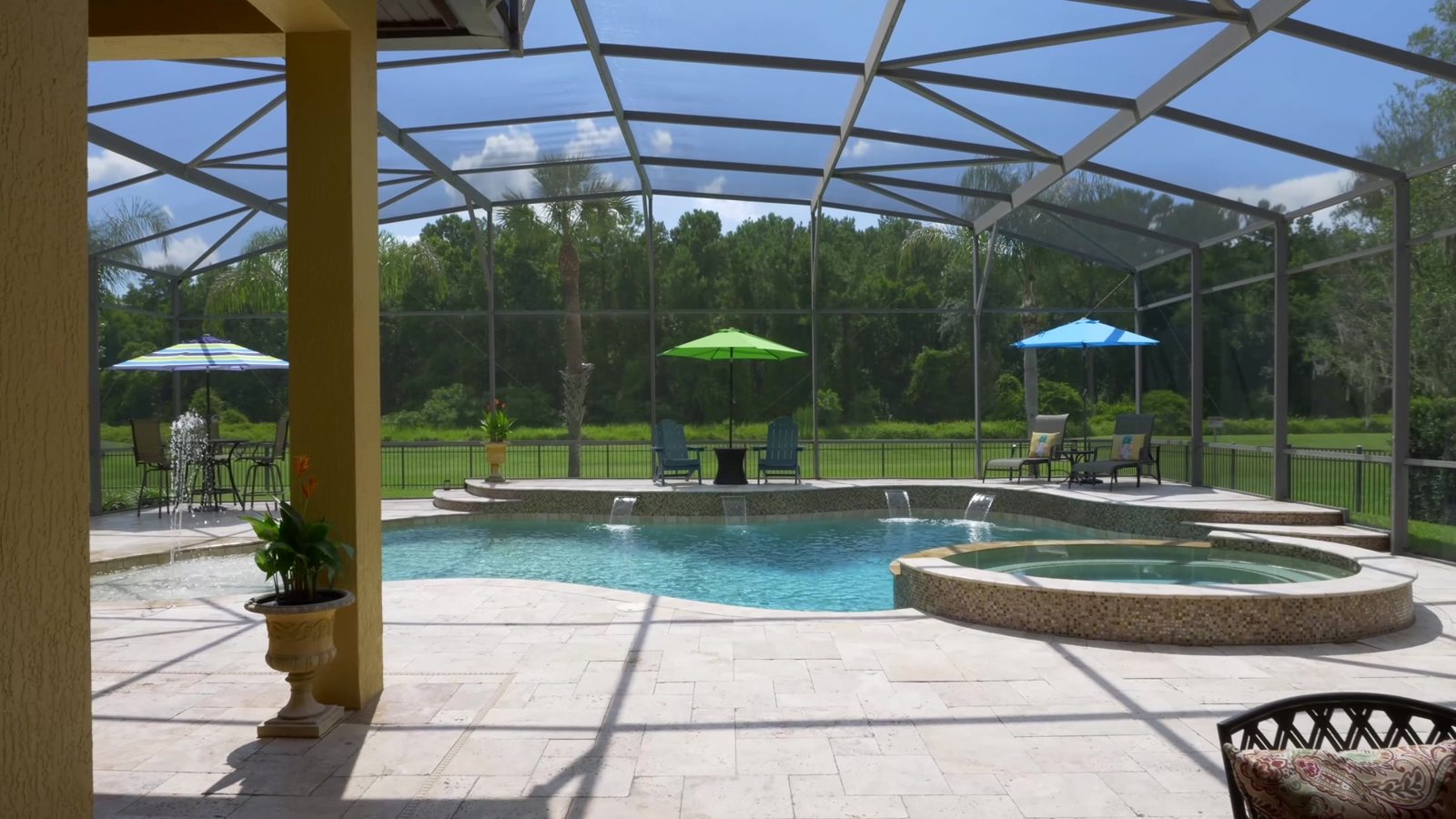 Resort-style screened pool and spa overlooking open green space at the Sanford estate