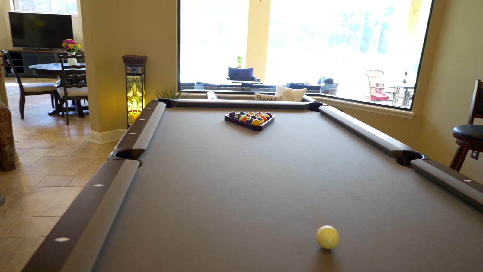 Billiards and game room with a pool table and stone accents in the Sanford luxury home