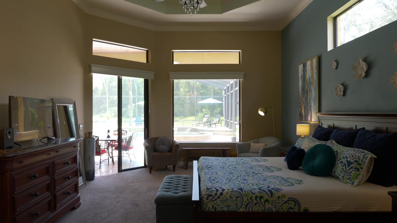 Spacious primary suite with pool views in the Sanford estate