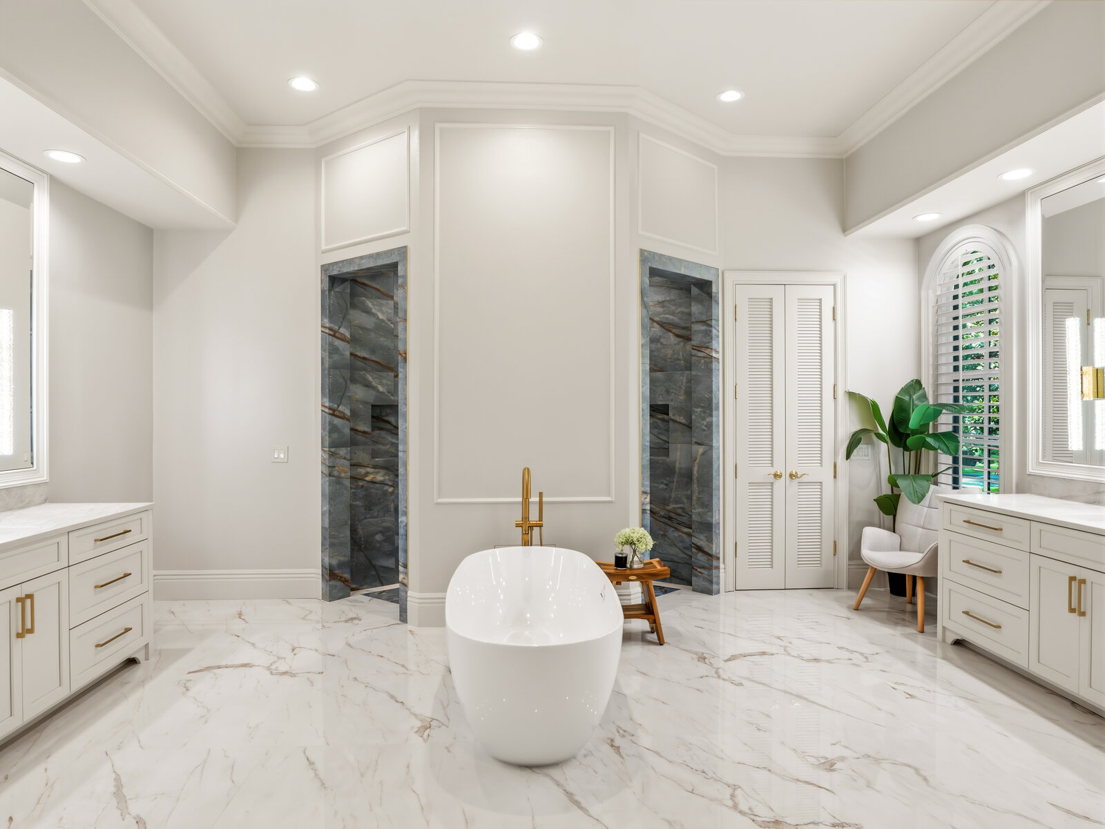Spa-like primary bathroom with a freestanding soaking tub, marble surfaces and brass fixtures